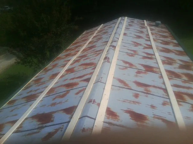 Rusted metal roof panels with new wood purlins before replacement — Storm Damage Roof Repair in Califon by Roofing Brothers