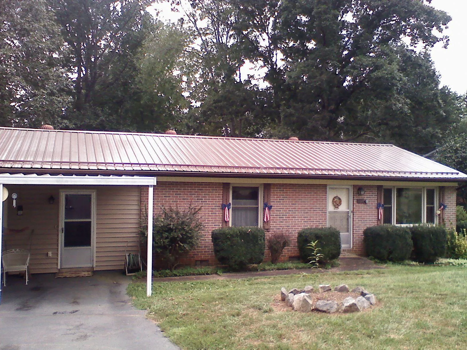 Bronze metal roof and carport on a brick ranch home — Roof Repair work by our crew in Califon