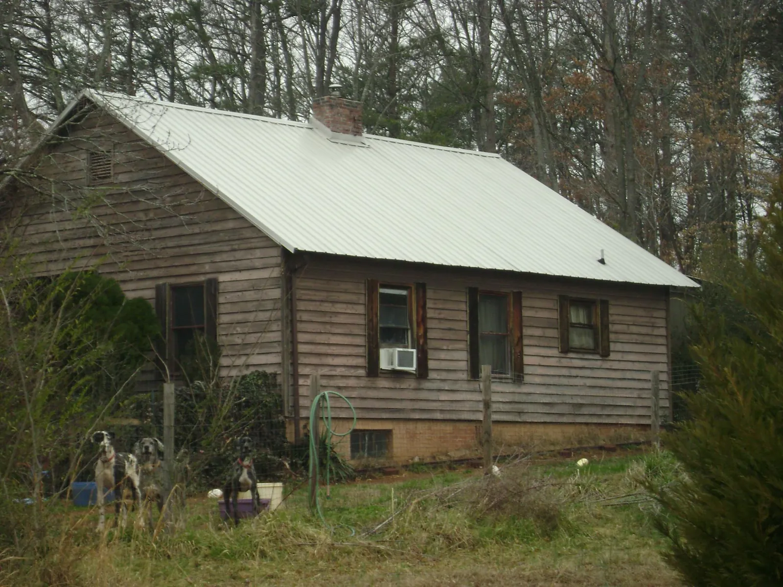 White metal roof on an old wood sided farmhouse, from a Metal Roof Installation job in Califon